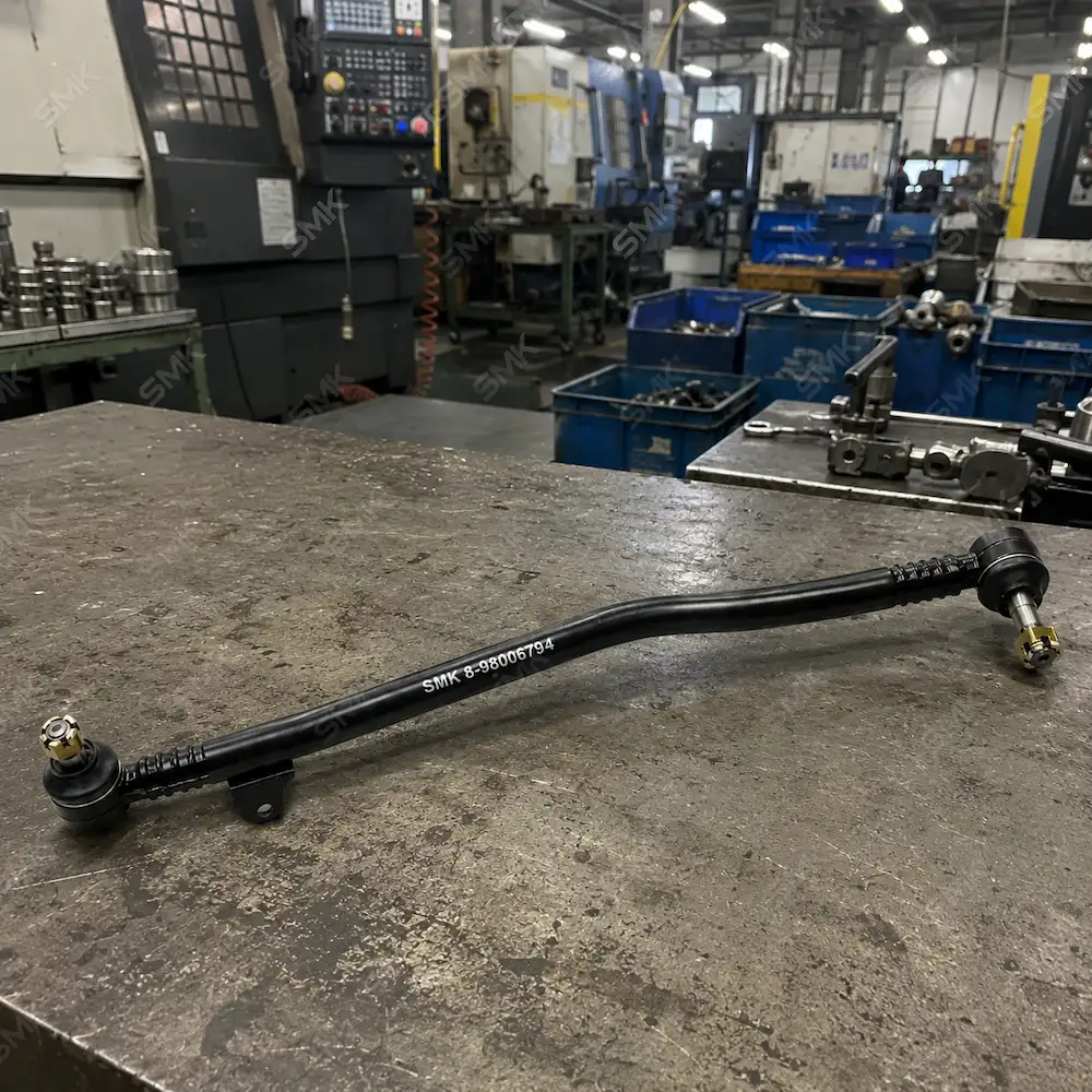SMK heavy-duty truck drag link assembly displayed on factory inspection table