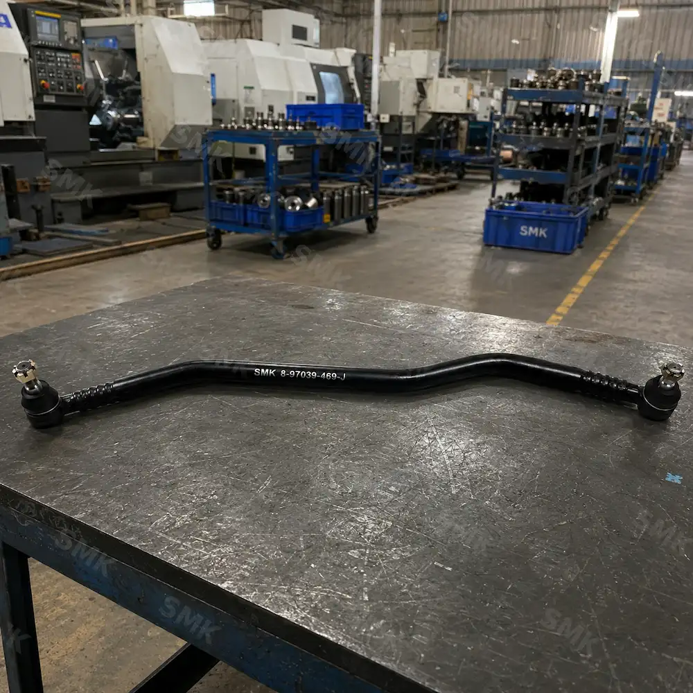 SMK curved heavy-duty truck drag link assembly on factory inspection table
